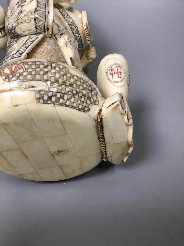 A Chinese engraved and stained bone figure of Budai, height 29cm